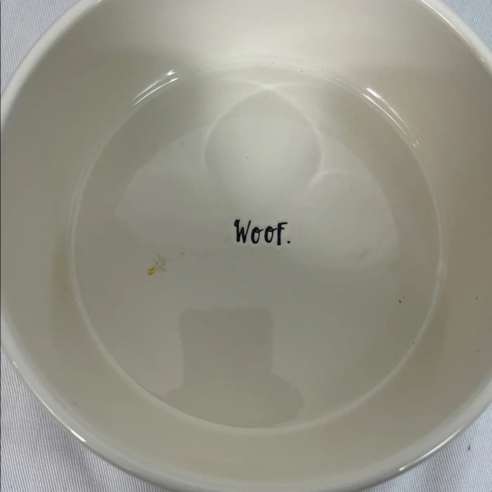 NWOT Rae Dunn white dog bowl 6”wide, 3”tall. Stick on front, WOOF inside bottom